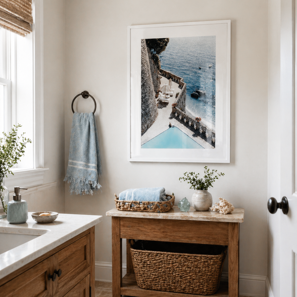 Bathroom interior with wooden vanity, framed artwork, and decorative elements.