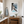 Bathroom interior with wooden vanity, framed artwork, and decorative elements.