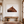 Framed picture of a horse head on a wall above a wooden bench in a room.