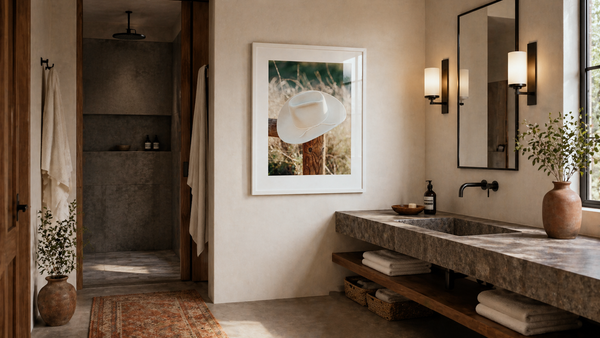 Wall art, Western, Rustic ARt, interior design, Modern bathroom with concrete sink, framed artwork, and natural light.