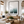 Living room with a large framed picture of a beach scene on the wall.